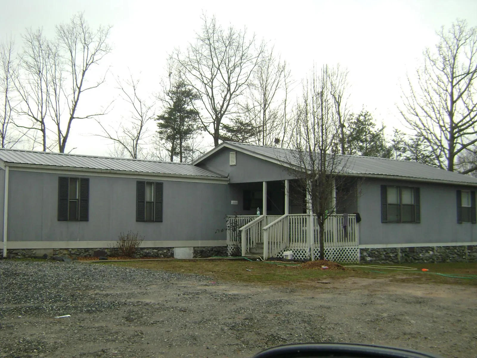 Metal roof over a manufactured home with a covered front porch in Prairie Village