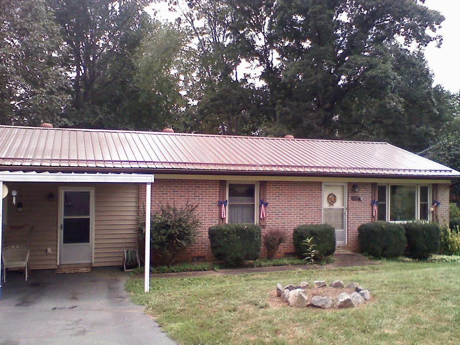 Bronze metal roof and carport on a brick ranch home — Roof Repair work by our crew in Prairie Village